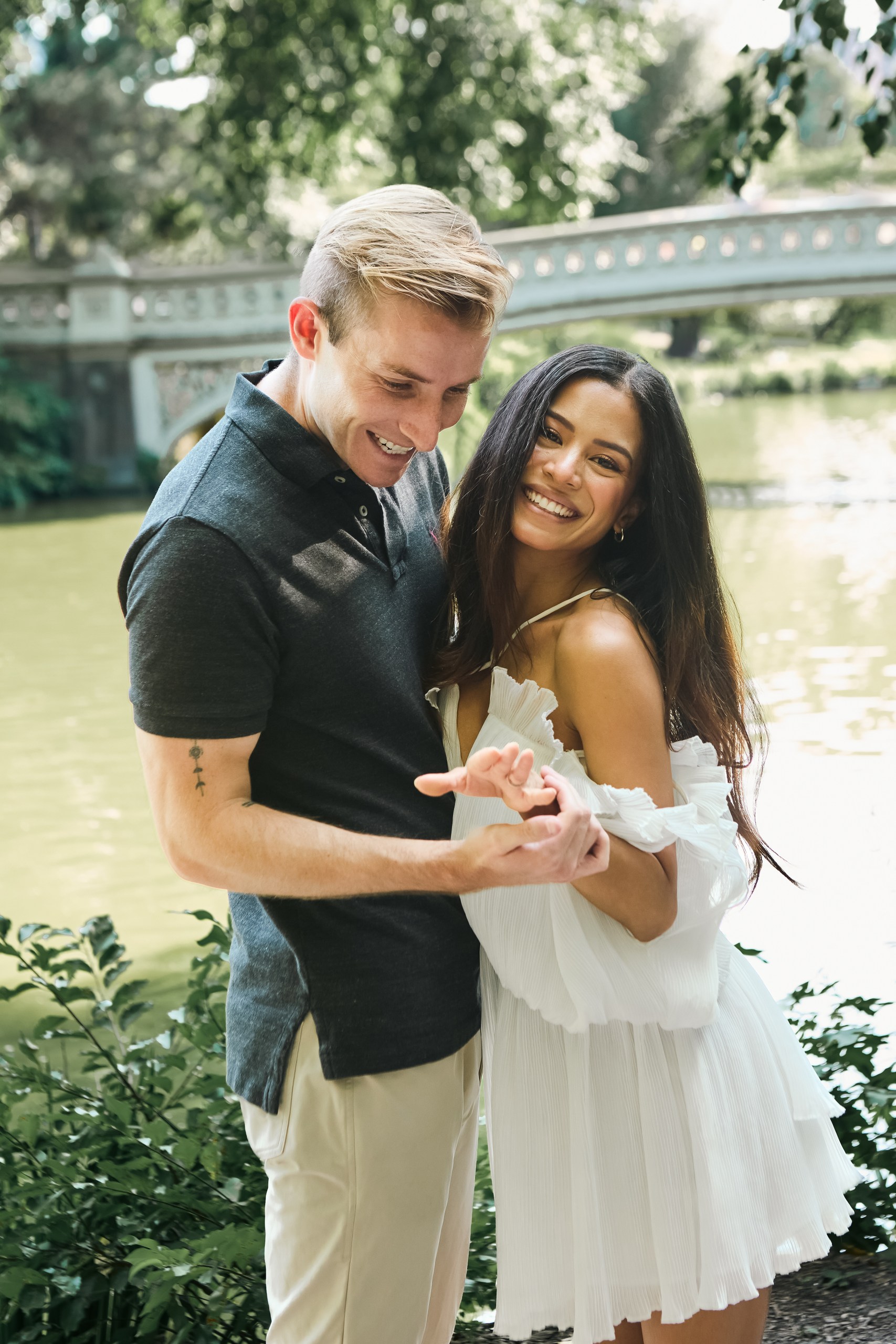 Couple embracing during a surprise proposal in Central Park, NYC